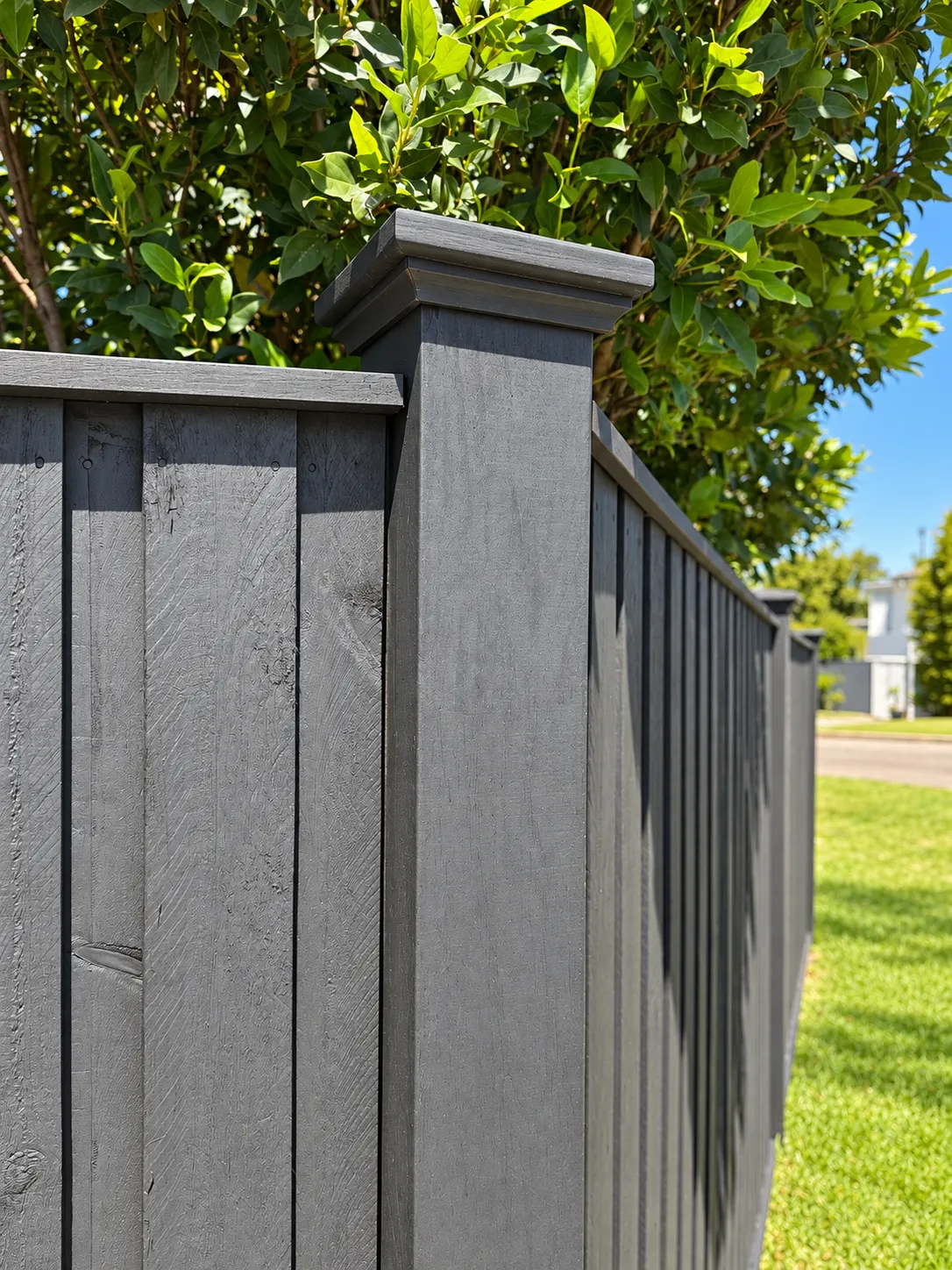 Painted timber fence post against a blue sky