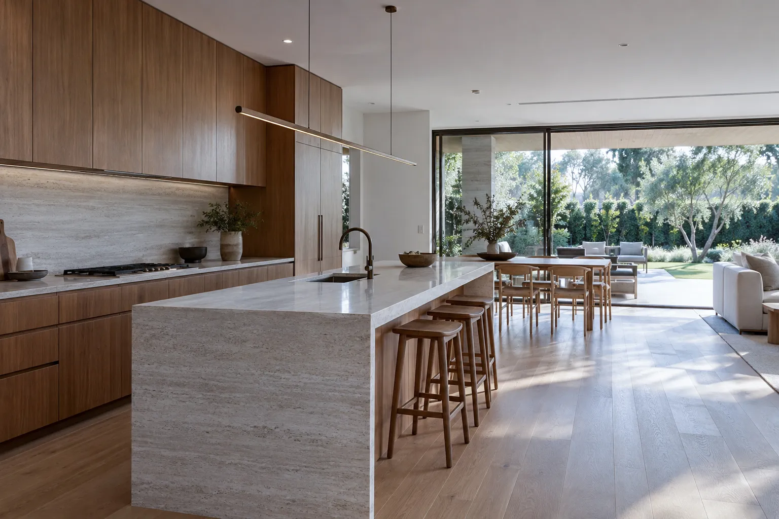 Kitchen with timber joinery and stone island opening to the garden