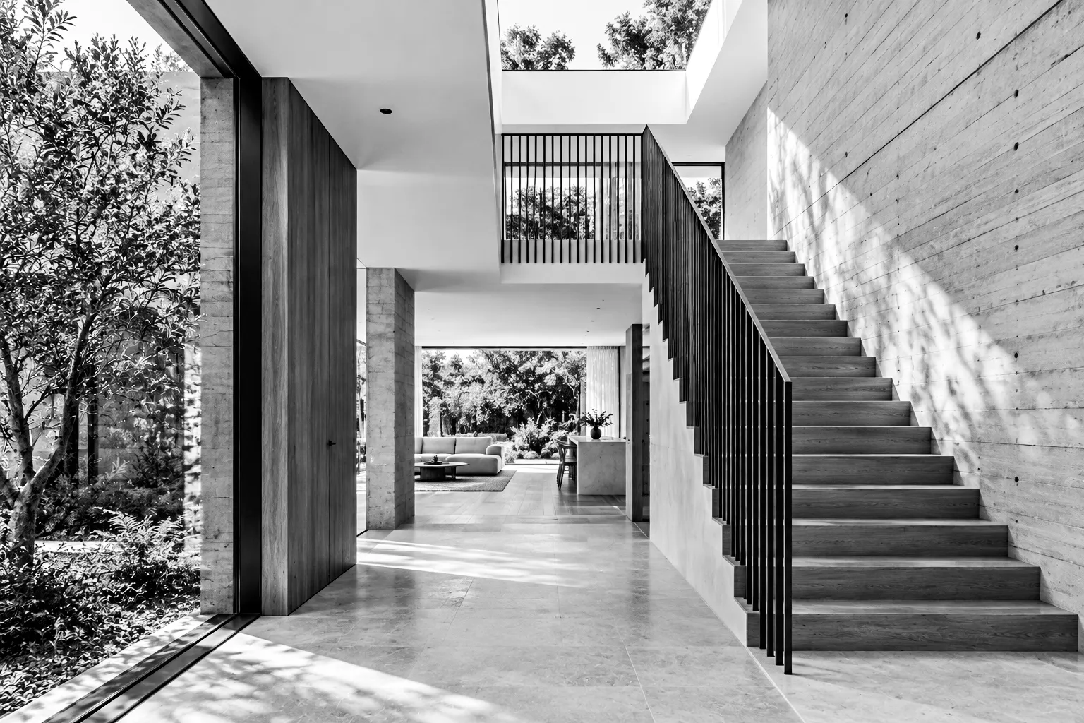 Entry hall and stair looking through to the garden, black and white