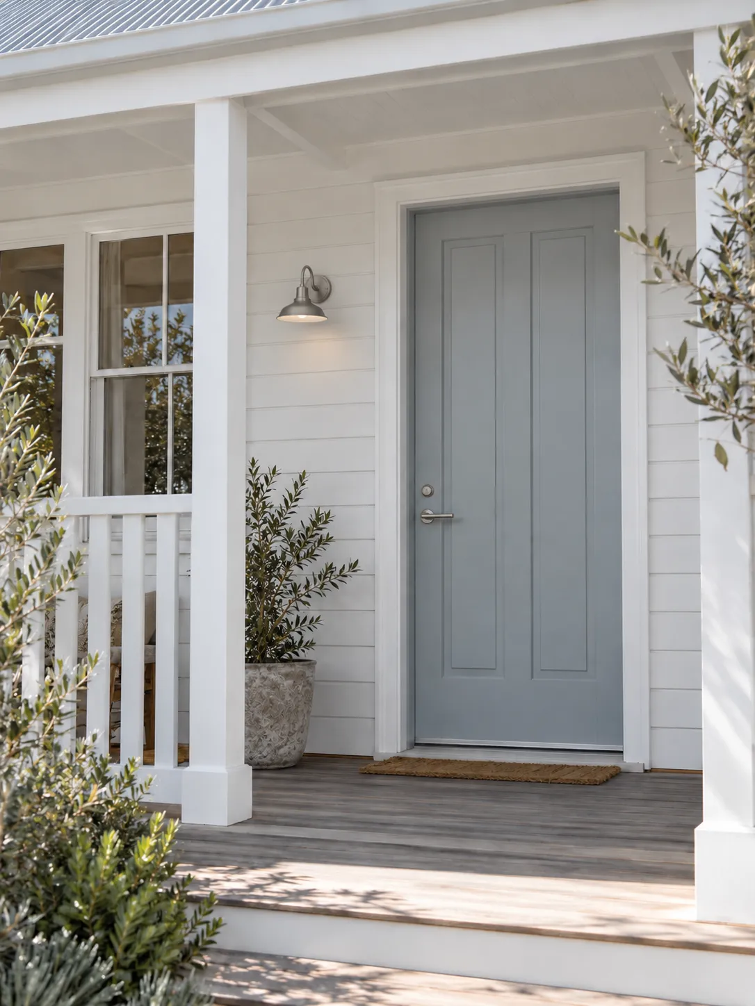 Front door in soft blue-grey beside a white verandah